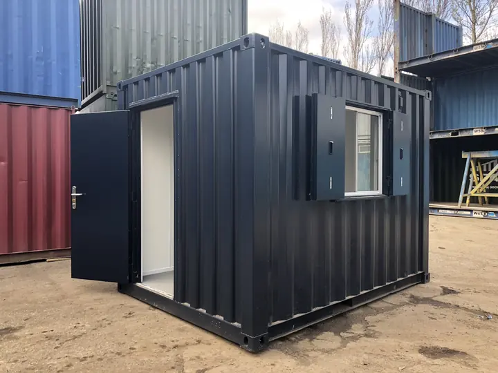 Real photo: a black 10ft container converted into an office, with a door and a shuttered window