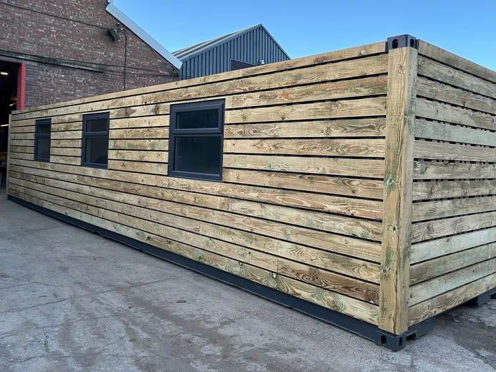 Real photo: 40ft timber-clad, with windows container conversion