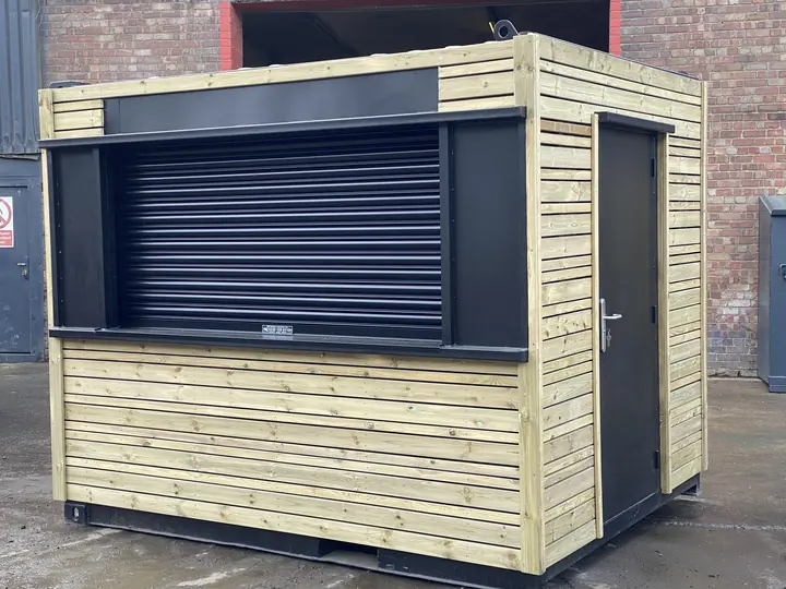 Real photo: timber-clad, with a roller shutter container conversion